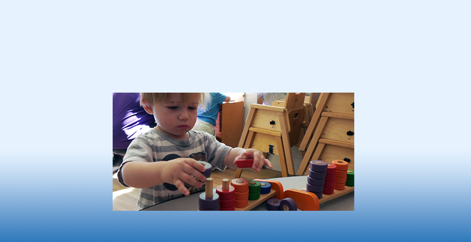 A child playing with ring and peg game that can help teach counting and pattern recognition.